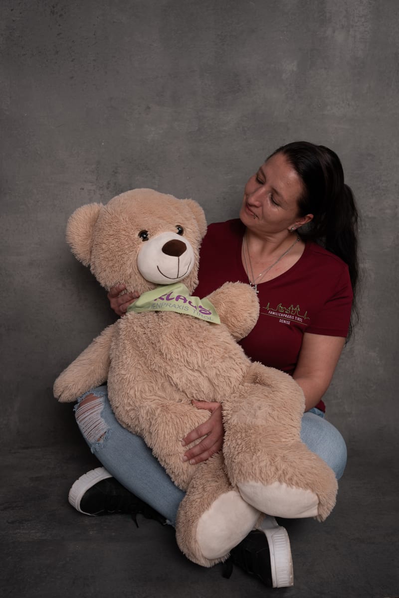 Denise, cleaning and hygiene assistant, with Klaus, the practice mascot