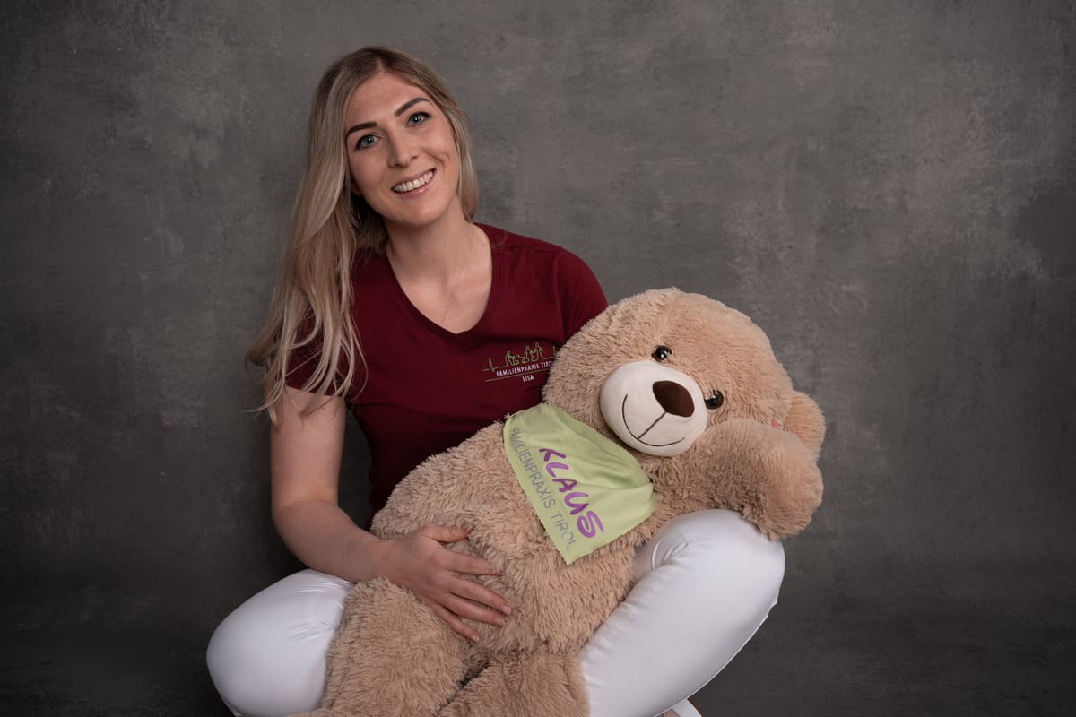 Lisa, registered nurse, with Klaus, the practice mascot