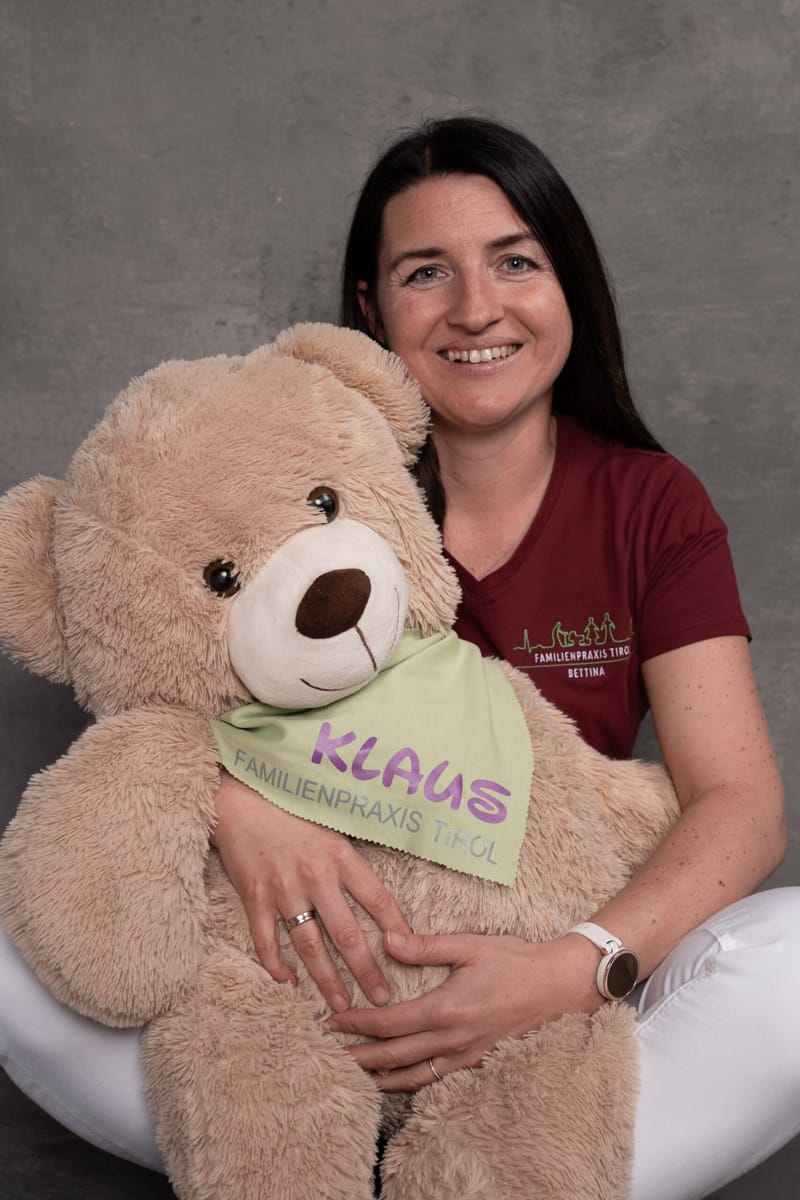 Bettina, practice assistant, with Klaus, the practice mascot